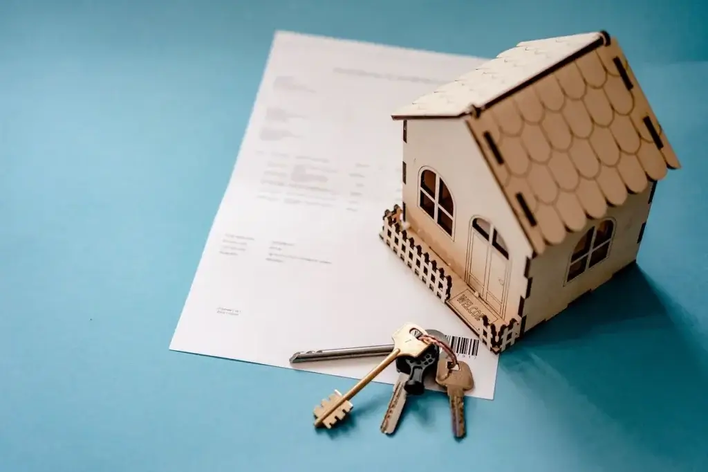 Image that shows a small wooden house next to a set of keys for the blog about what a wood destroying insect inspection is.