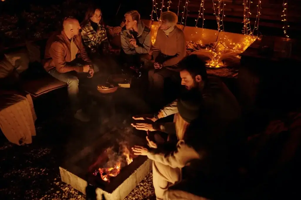 People gathered around a fire pit at a bug-free backyard party.