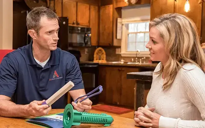 Male pest control expert explains bed bug inspection results to homeowner. Bed Bug Control Blowing Rock, NC.