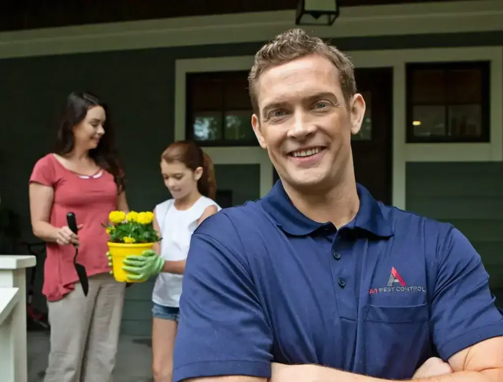 Male pest professional provides radon mitigation to a family home in Hendersonville, NC.