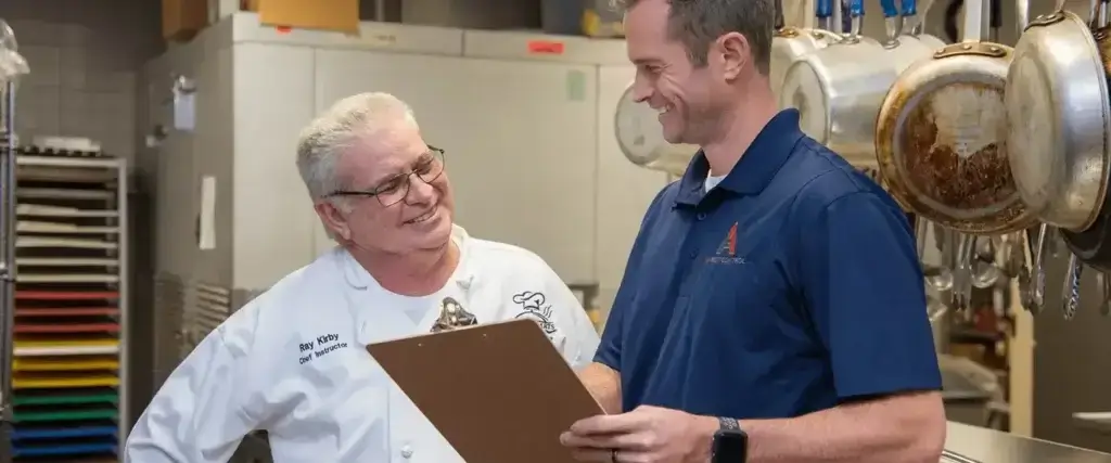 Two men reviewing results of a pest inspection, highlighting the need for commercial pest control in Lenoir.